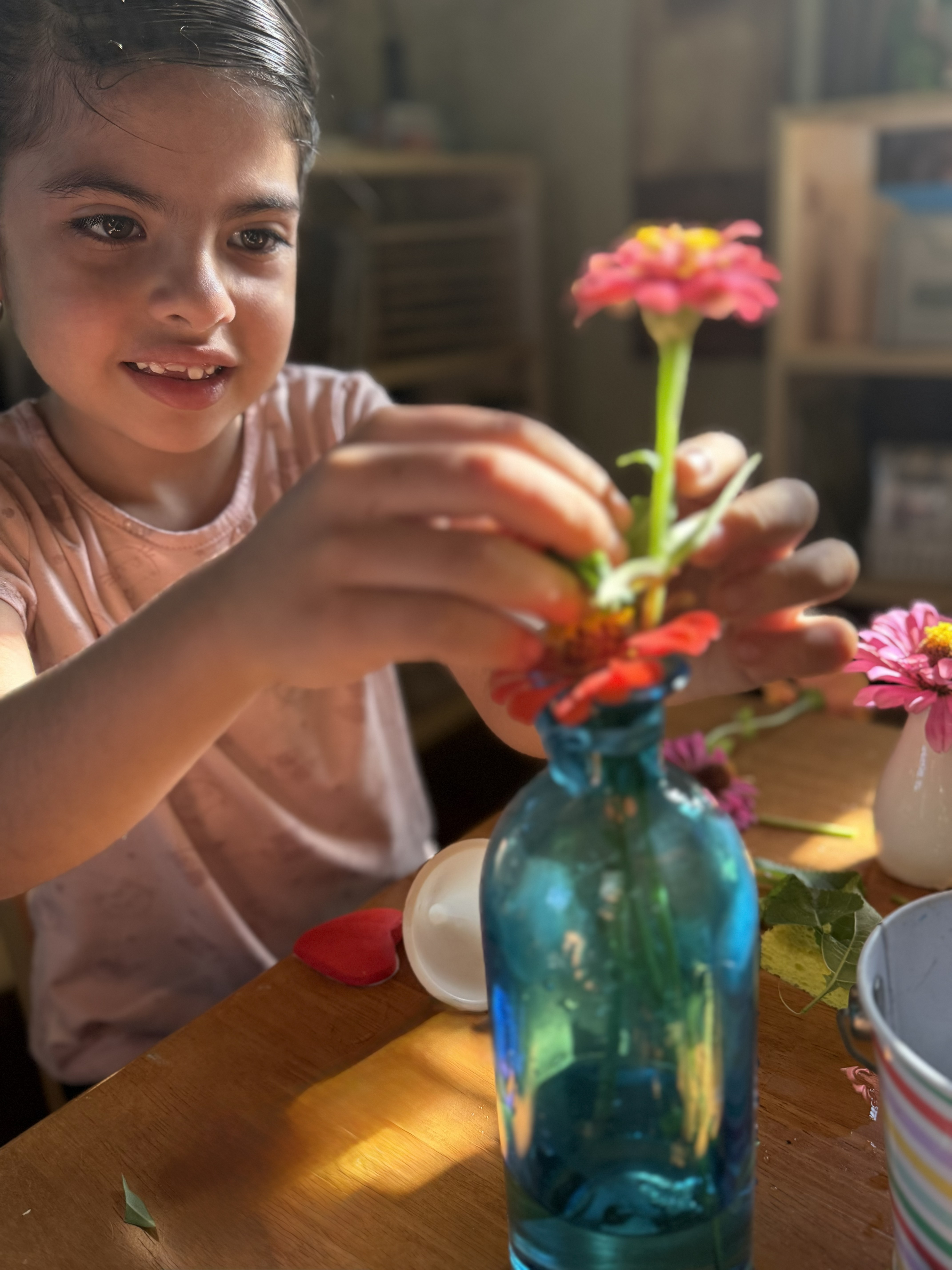 A child arranging flowers at Bayou Blossoms