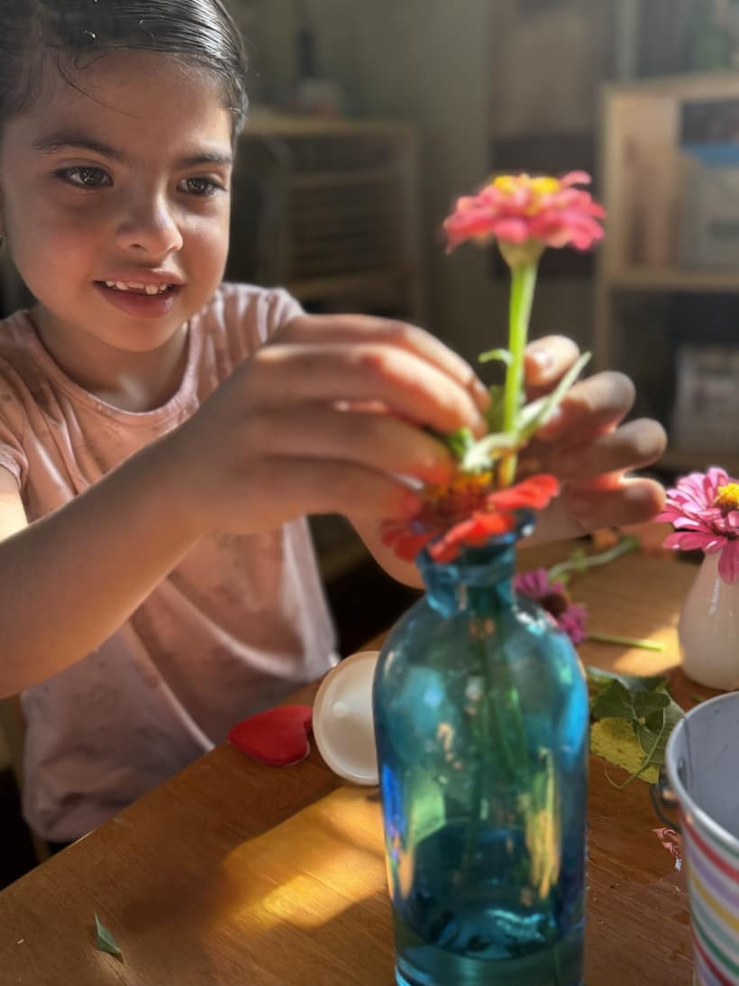 A child arranging fresh flowers at Bayou Blossoms